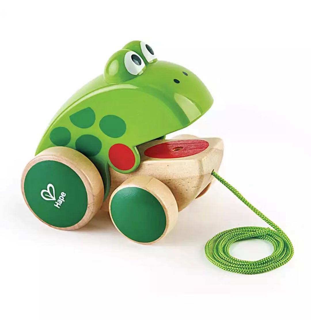 Frog dragging toddler hand-drawn toys